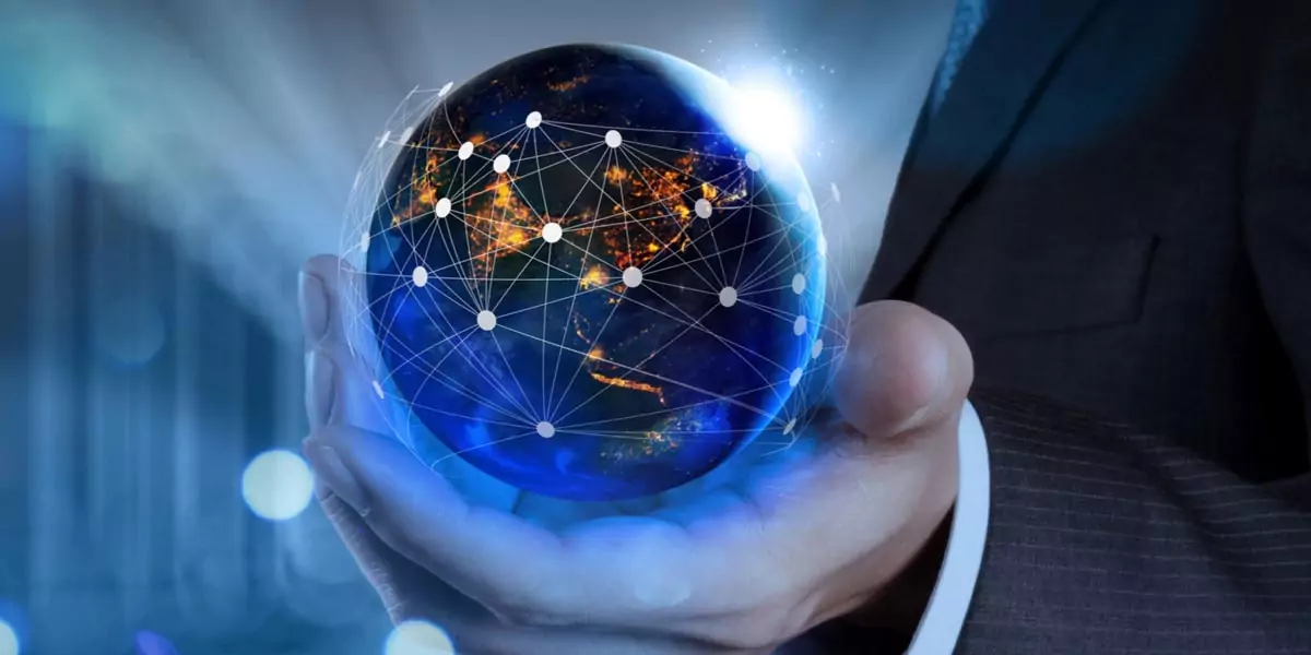 Businessman holding a glowing globe overlaid with a global network