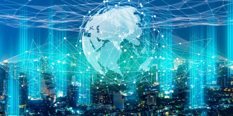 Glowing digital globe with network connections over a city skyline at night