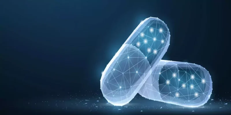Two glowing wireframe pill capsules representing pharmaceutical technology