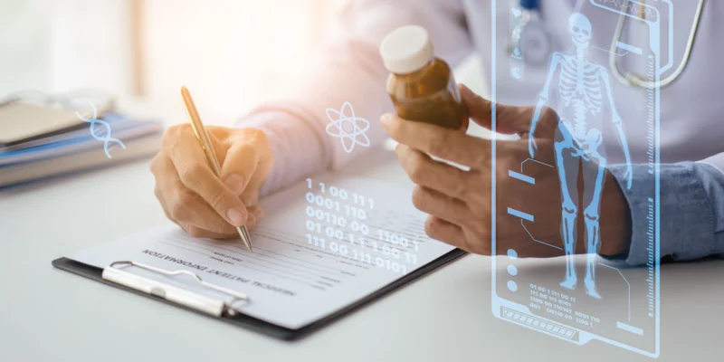 Doctor's hands writing on a patient chart beside a pill bottle
